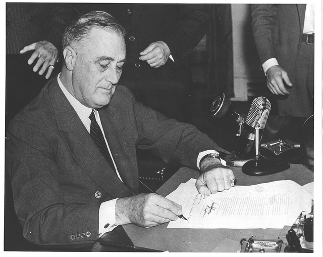 FDR signing the paperwork that created the Federal Communication Commission