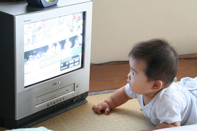 a baby starting at a television screen