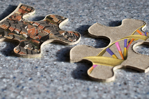 Two jigsaw puzzle pieces are shown; one depicts images of houses, and the other depicts a helical DNA strand.